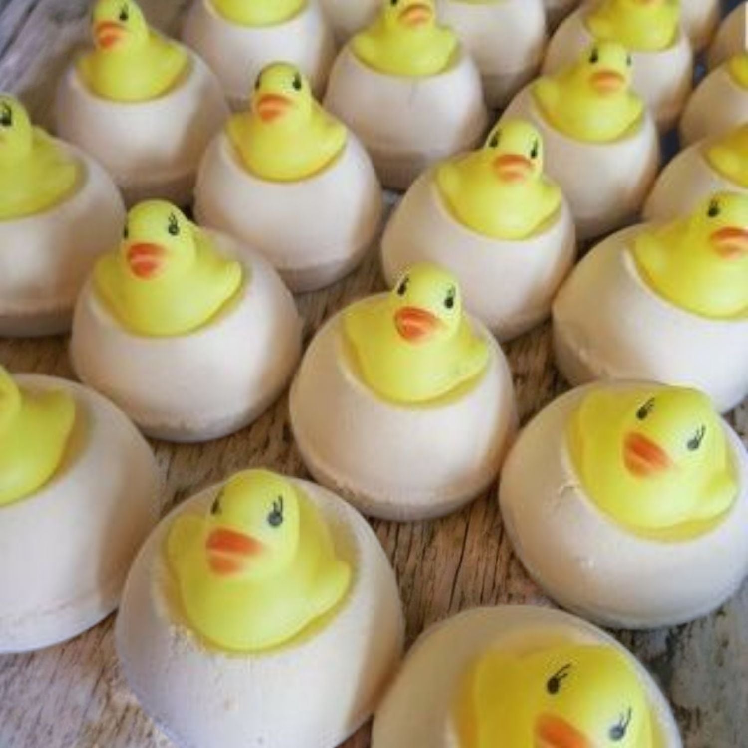 Lemon Sherbert Bath Bomb with a little Rubber Duck Bath Toy sitting on top